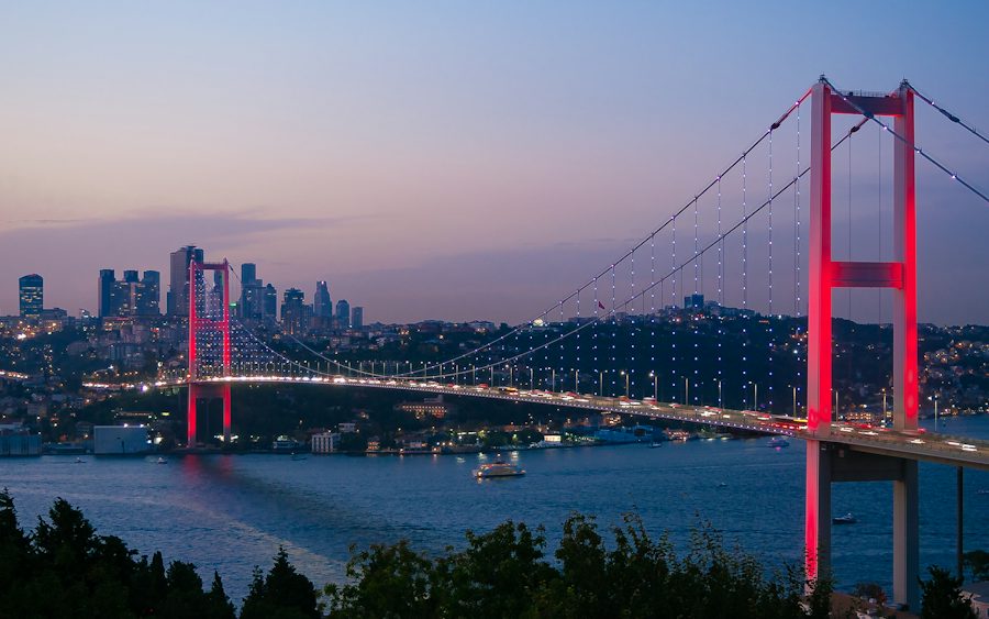 The Bosphorus Bridge at dusk with the city skyline behind